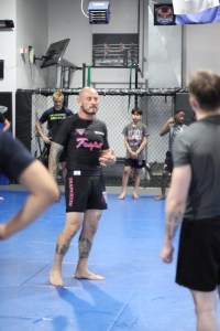 An instructor teaching an Uprising MMA class