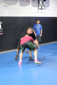Two athletes practicing wrestling at Uprising MMA