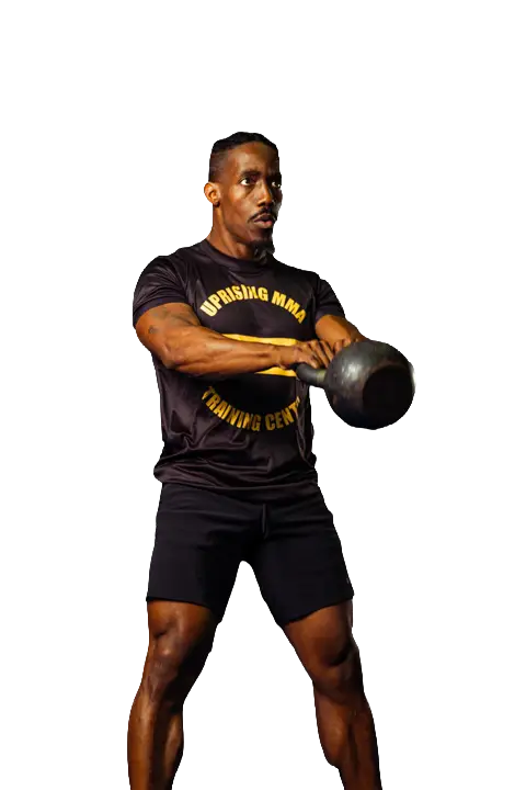 A Uprising MMA coach performing a kettlebell exercise